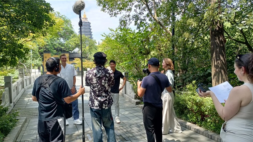 Dalian production crew reviewing a shoot on location